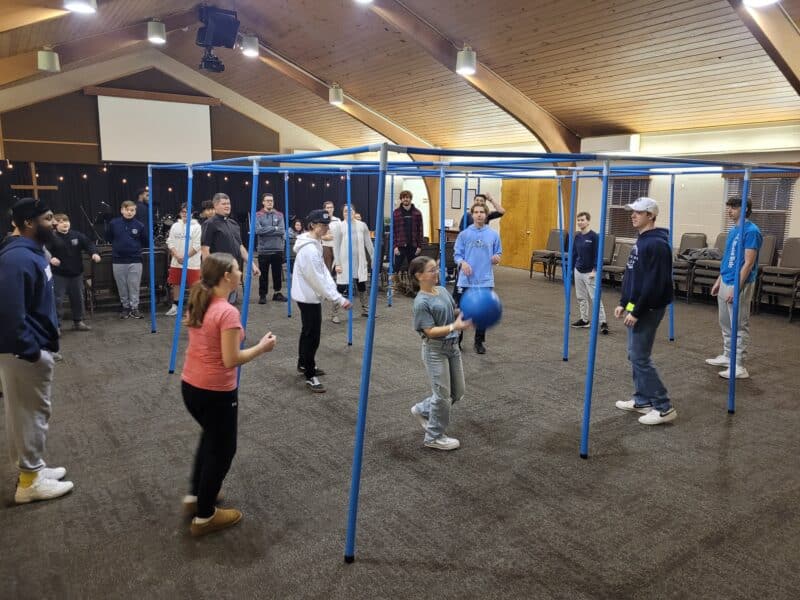 Photo of teens playing nine square in the air
